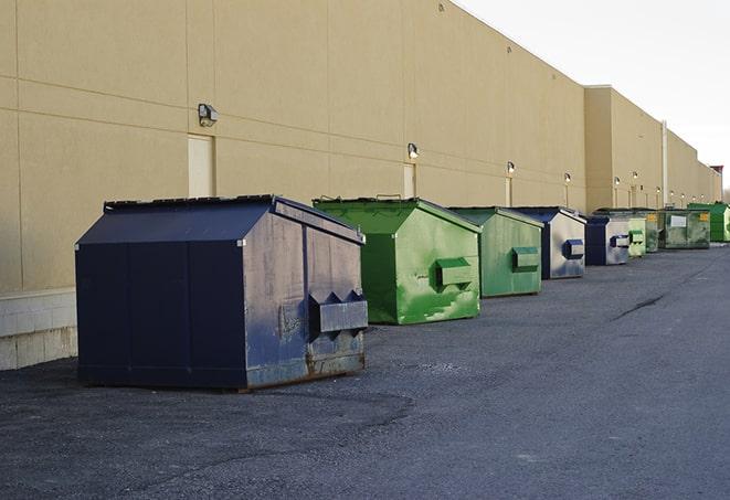 construction workers disposing of debris in large dumpsters in Essex Fells, NJ